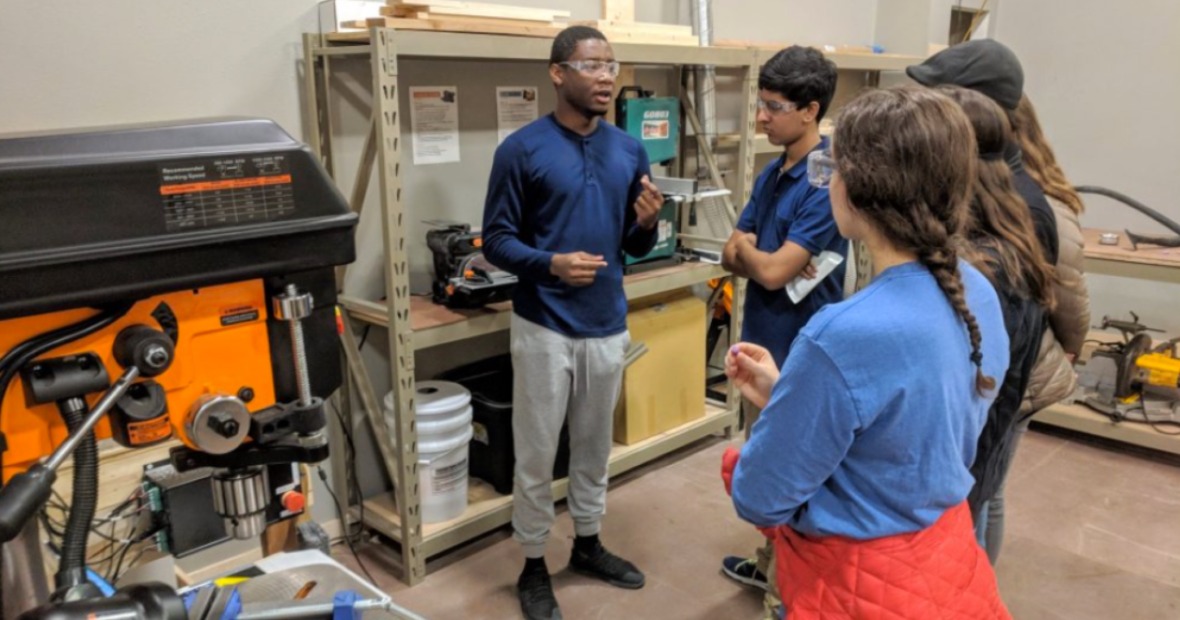 Students listen before crafting at the Stew Makerspace