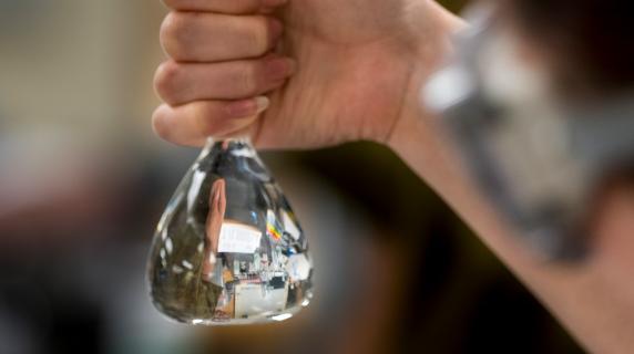 hand holding a beaker