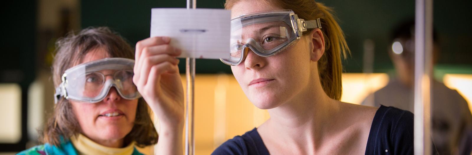 Leslie Lyons, Professor of Chemistry, works with a student in one of the labs in Noyce