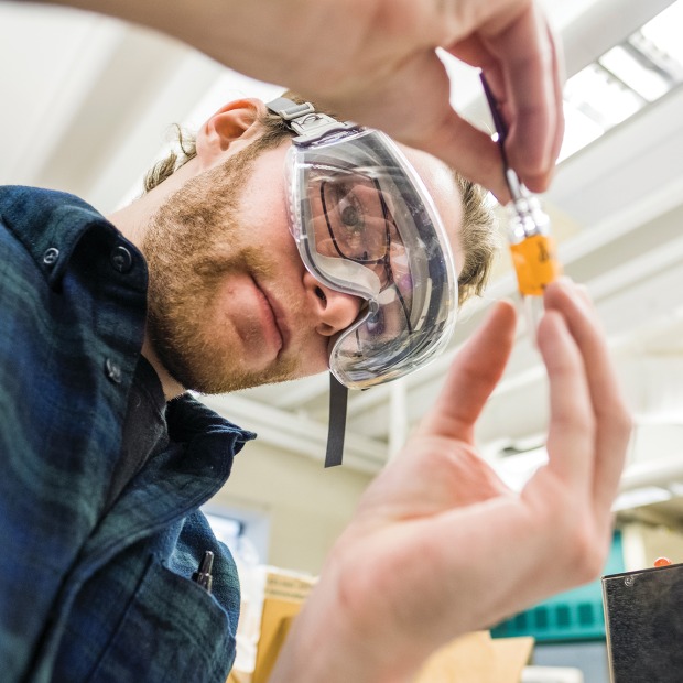 A student analyzing a Greek vase