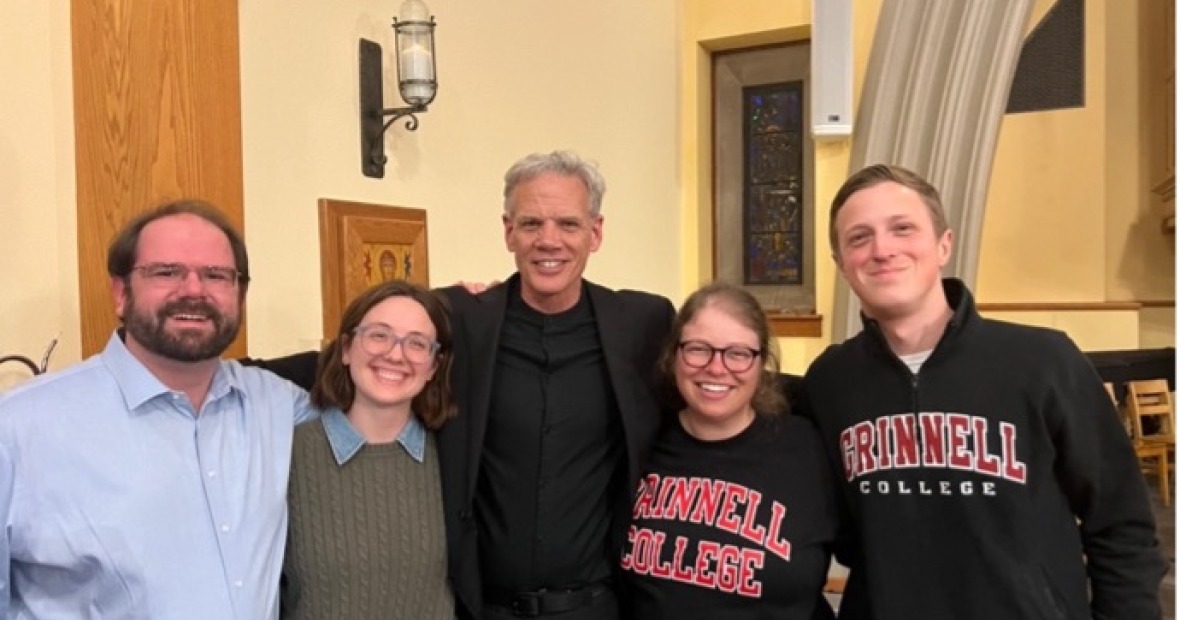 4 people, two in Grinnell College gear, stand with John Rommereim