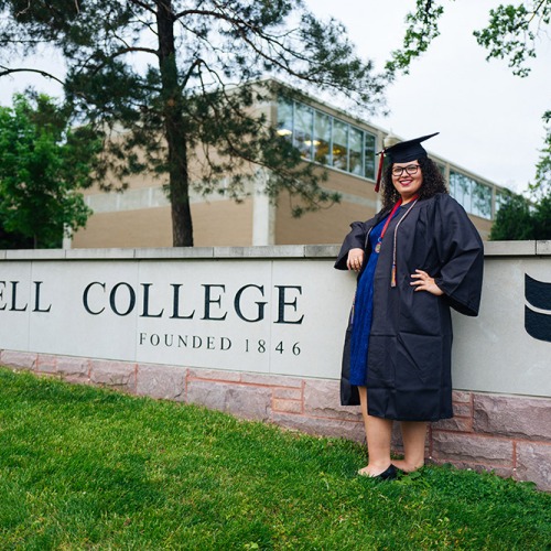 Denisha Renovales stands by Grinnell College entrance
