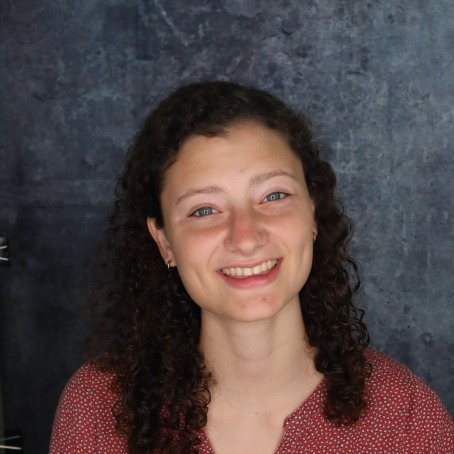 a woman smiles for a headshot