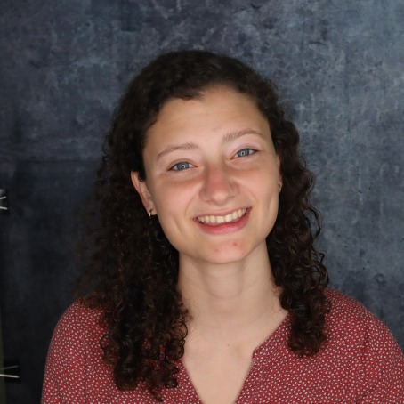 A woman smiles for a headshot