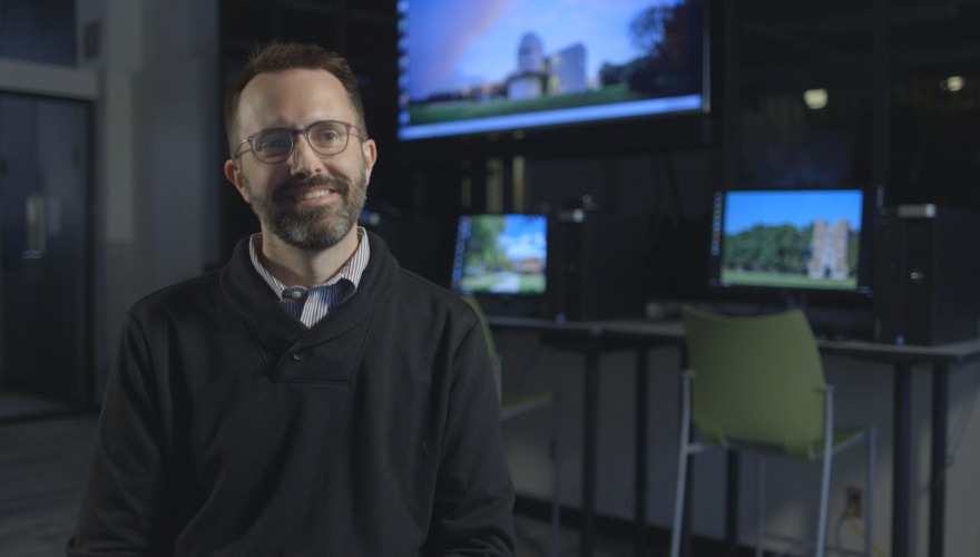 Erik Simpson in front of monitors