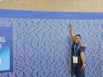 I point to my name on the big blue wall.