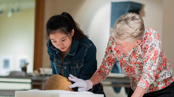 Student and professor examine a skull