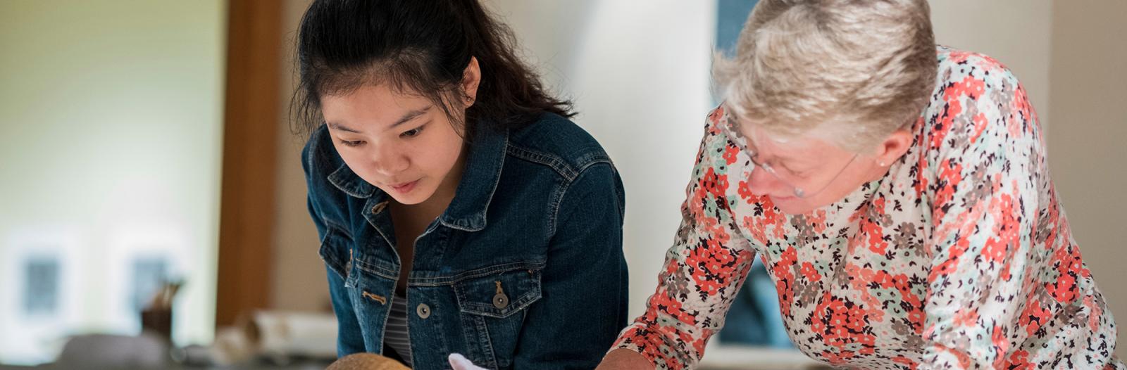 Student and professor examine a skull