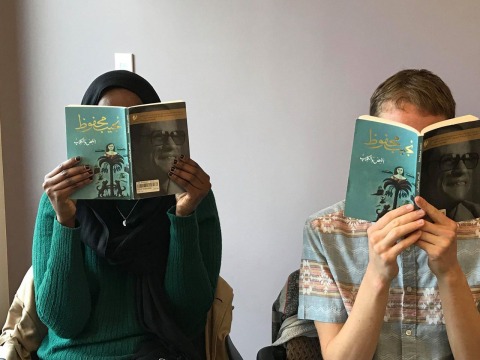 Farah Omer and Gray Streetman reading book, The Thief and the Dogs