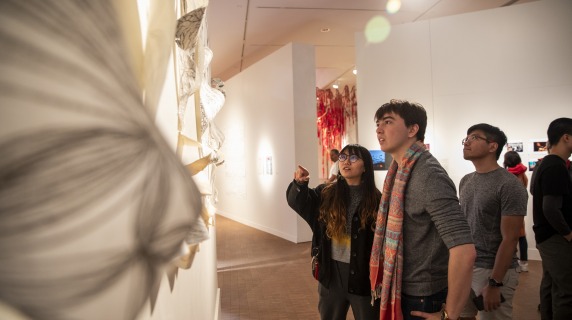 Guest discuss art hung on the Faulconer Gallery's wall