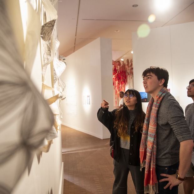 Guest discuss art hung on the Faulconer Gallery's wall