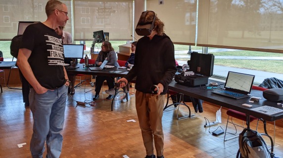 GCIEL director David Neville demonstrates a headset during the 2022 Teaching with Technology Fair