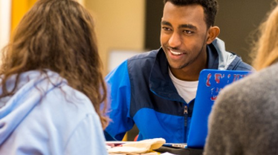 Students sitting at a table, talking