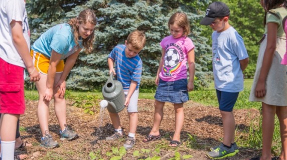 Six children watering garden