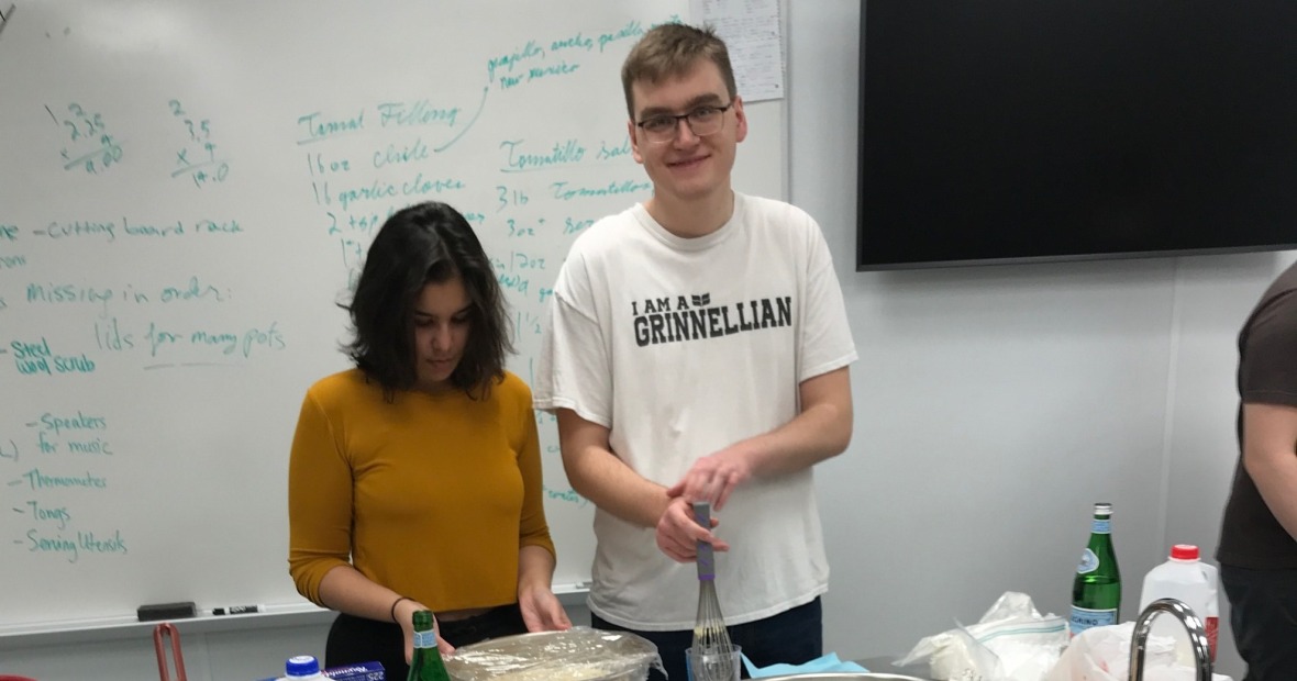 Student standing by the tamales they made