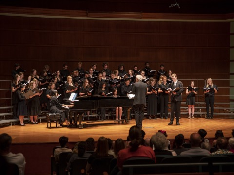A vocal ensemble performs onstage