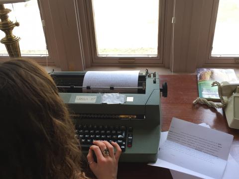 back of student at typewriter