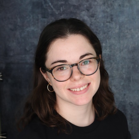 A woman smiles for a headshot