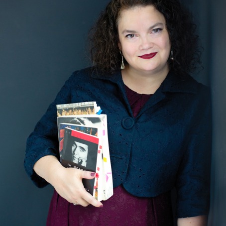 Dr. Jen Shook holding books