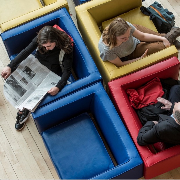 View from above, people sitting in colorful chairs in Spencer Grill