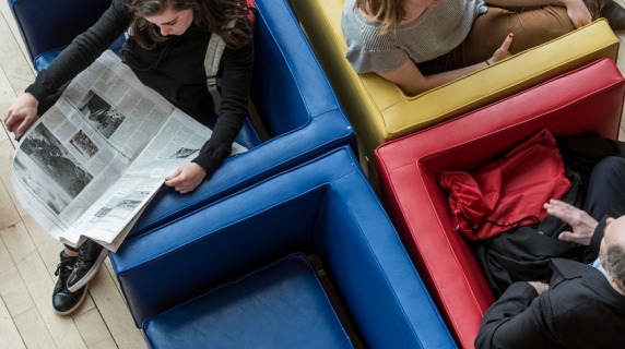 View from above, people sitting in colorful chairs in Spencer Grill