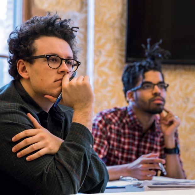 two students listen in classroom