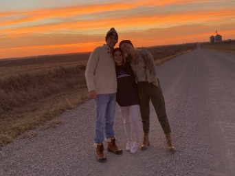 My favorite coaches and I hugging each other with the sunset in the background