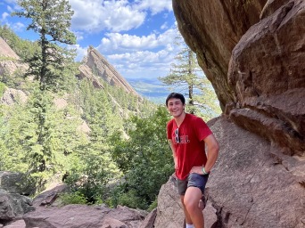 I stand below some shades on a mountain trail.