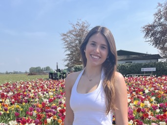 I stand near the blooming tulip flowers.