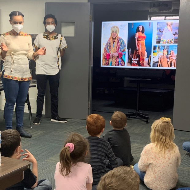 Feven Getachew and Simon Taye talking to elementary students