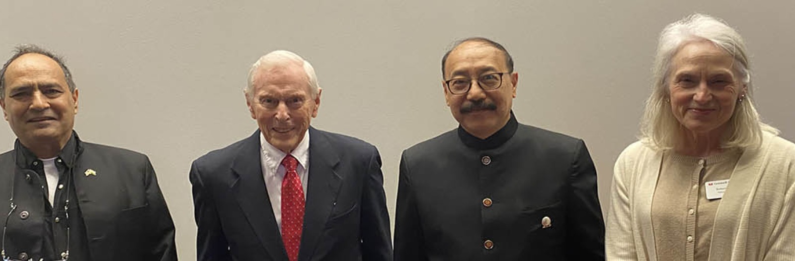 Four people stand in a group shot, with Ambassador Shringla second from right