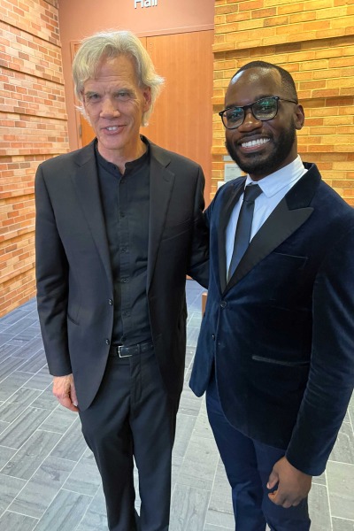 John Rommereim and Joel Thompson stand arm in arm 