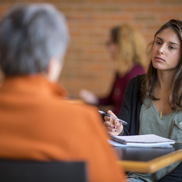 A student talks with a faculty member