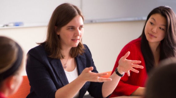 Faculty member talking to students.