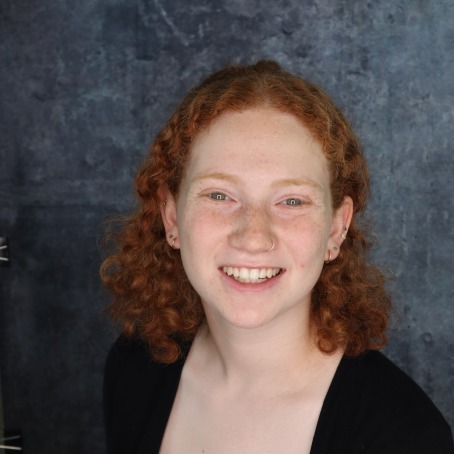 A woman smiles for a headshot