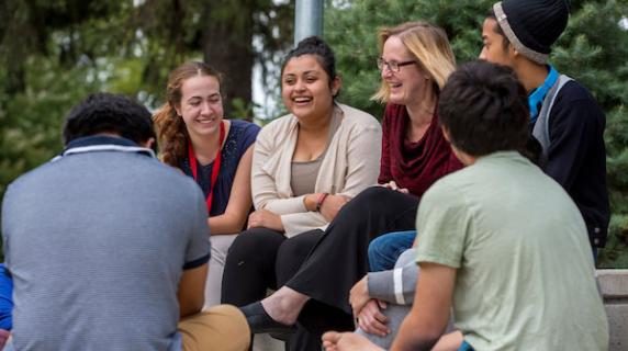 students and mentor outdoors
