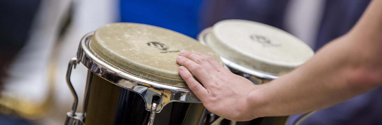 Student playing instrument during Mark Laver, Assistant Professor of Music Rehearsal