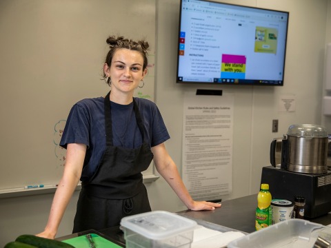 Nora Leahy smiles as she takes a break in the Global Kitchen