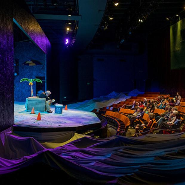 Scene from play Nice Fish - man on couch