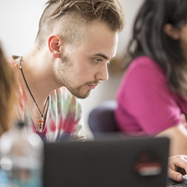 Student works on computer in classroom