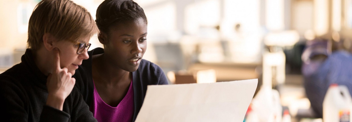 Student and facutly at computer