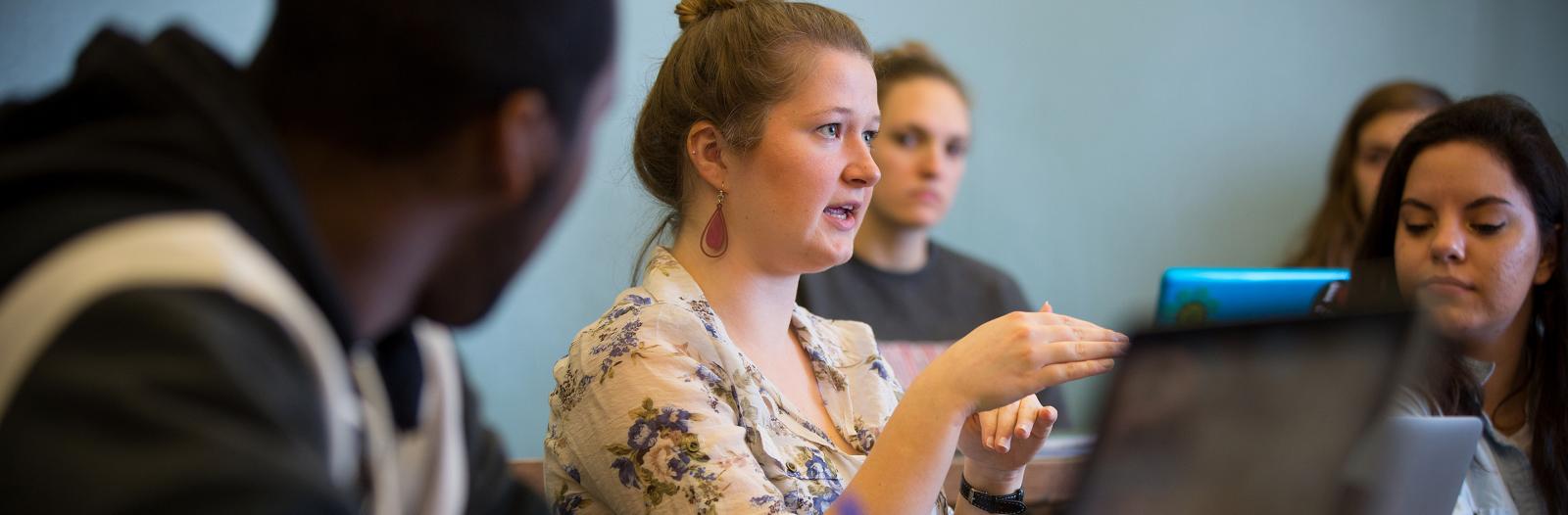 Student talking during classroom discussion 