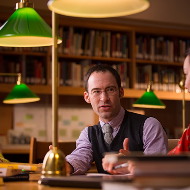Caleb Elfenbein talk with student in the rare book room