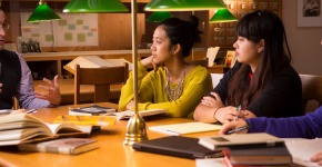 Caleb Elfenbein, Assistant Professor of History and Religious Studies meets with a small group of students in the Iowa Room in the basement of Burling Library