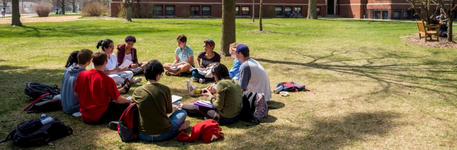 Students having class outside on the grass