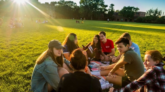 Students smiling on a field.