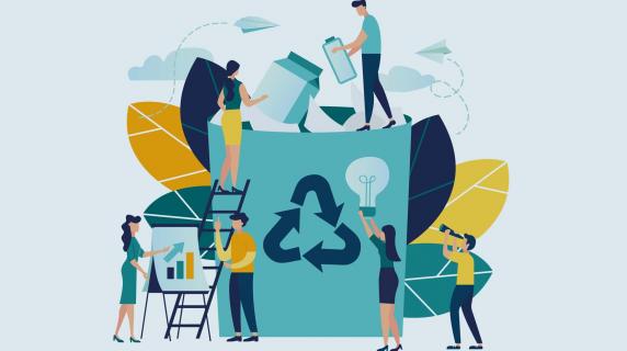 people adding items to a giant recycle bin