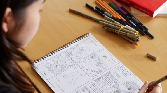 Sam Nakahira sketching a page for her book