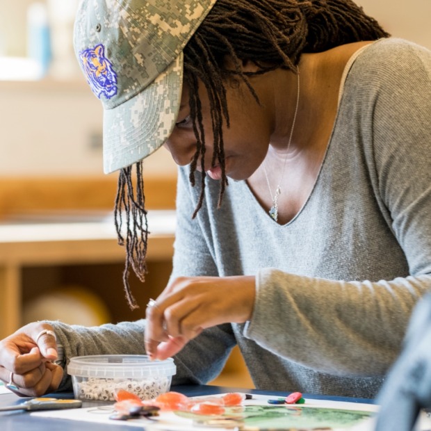 Student creating mixed media collage