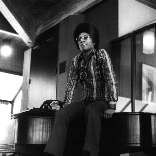 Herbie Hancock sitting on a piano in the Forum